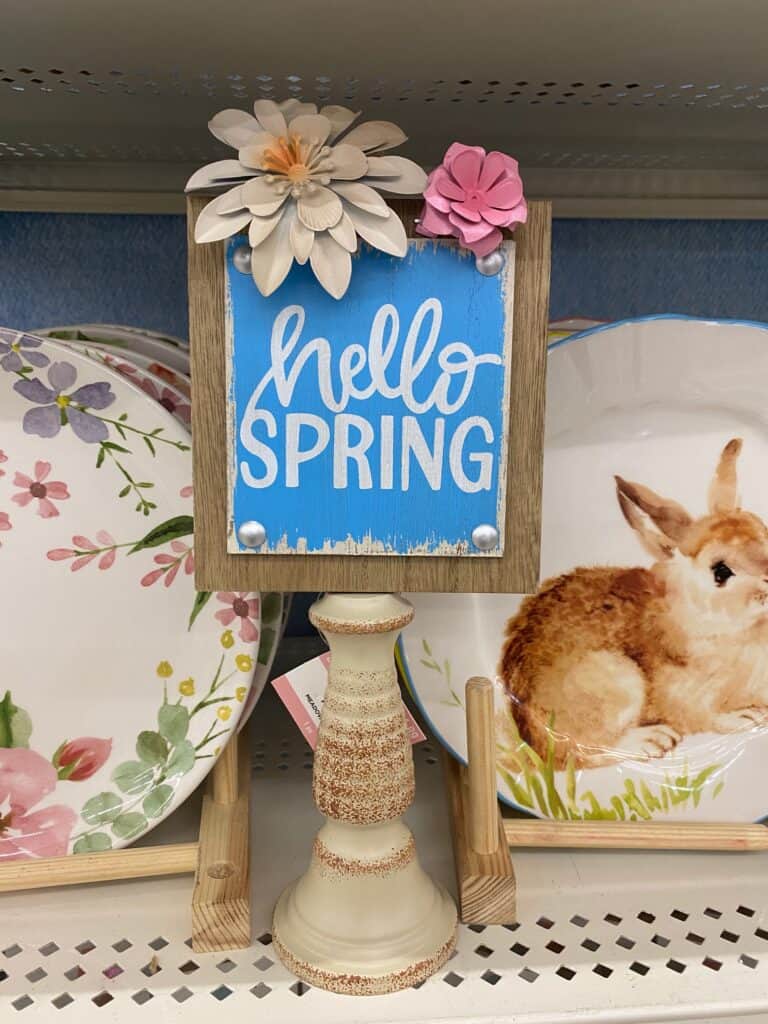 Hello Spring sign with flowers on a candlestick.
