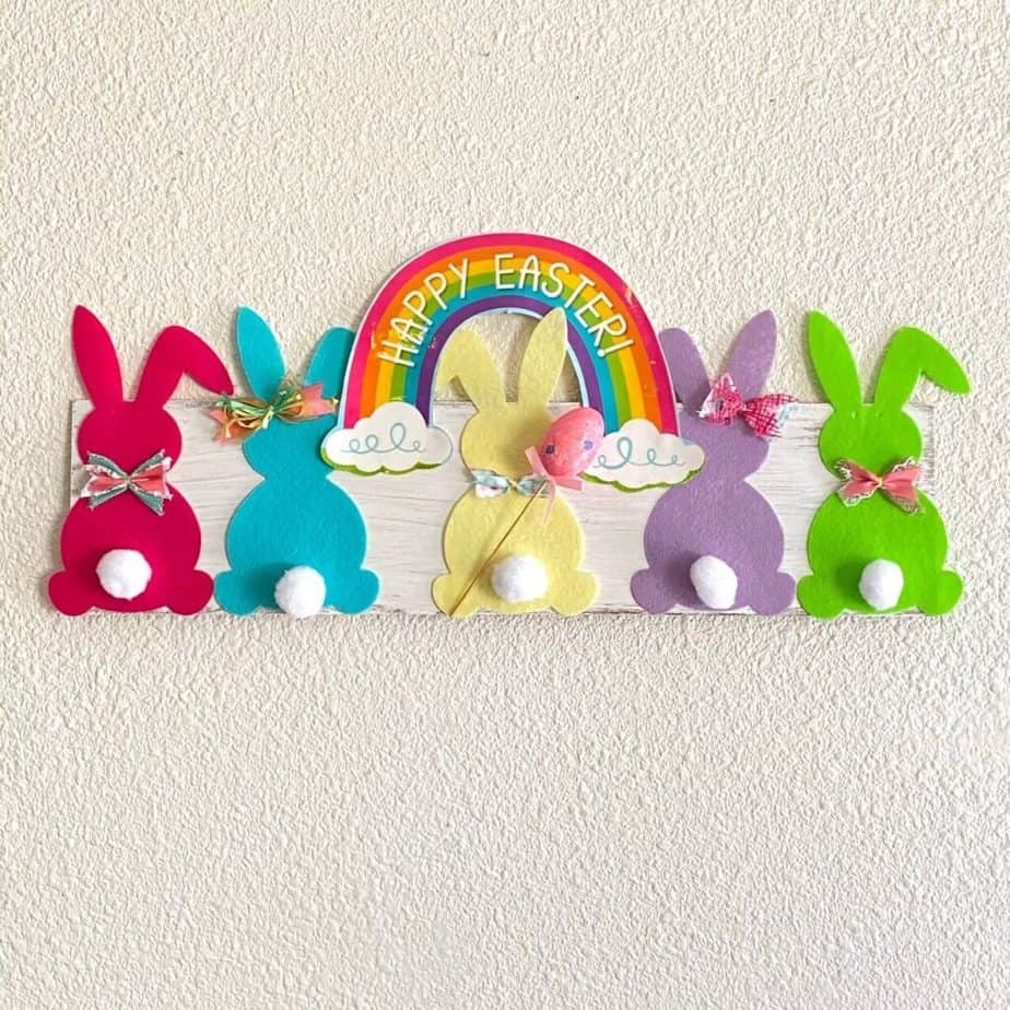 DIY Dollar Tree Rainbow Bunny Sign made from a Banner for easy to make Easter holiday decor that says "Happy Easter".