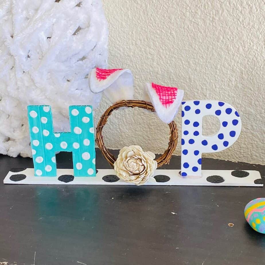 Easter "HOP" Shelf Sitter, easy piece of DIY easter decor with pastel polka dot letters and an O with Bunny ears and a tail.