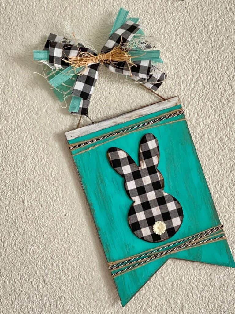 DIY Dollar Tree Teal and Buffalo Check distressed Easter Bunny wooden sign craft with a messy scrap ribbon bow.