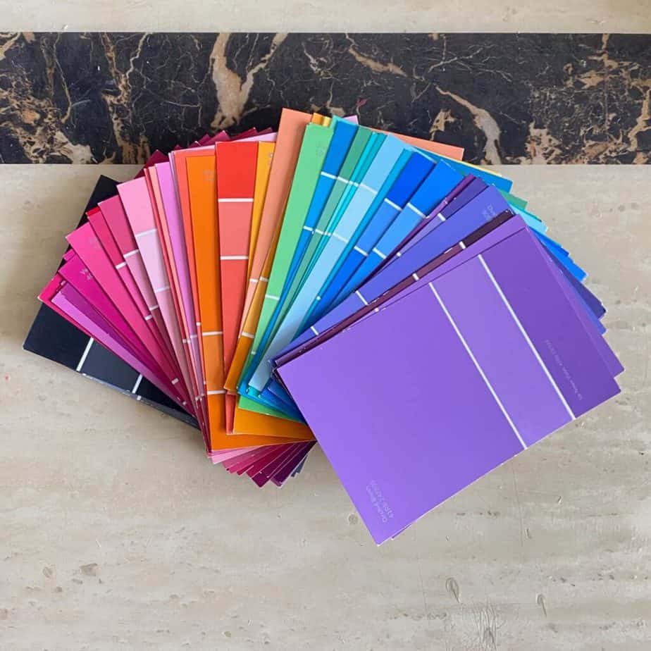A whole array of paint samples fanned out in a rainbow colored pattern.