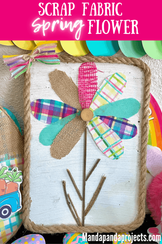 Scrap fabric and burlap ribbon colorful spring flower petals with a stick stem and white background with rope around the edge. DIY spring craft made with scraps.