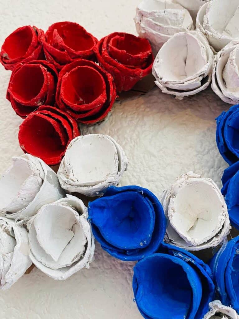 Close up of the red white and blue painted egg carton cups.