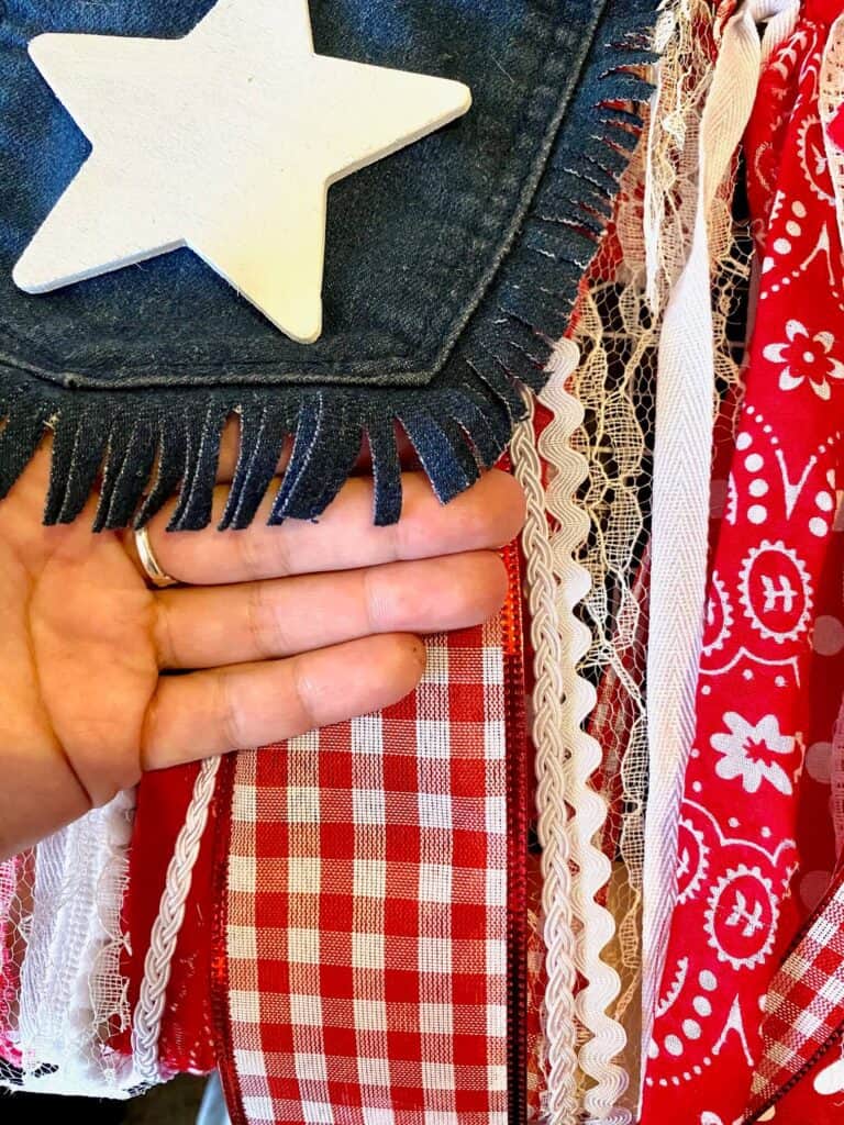 Use a rotary cutter or scissors to cut smaill slits of fringe around the outer edge of the blue jeans pocket.
