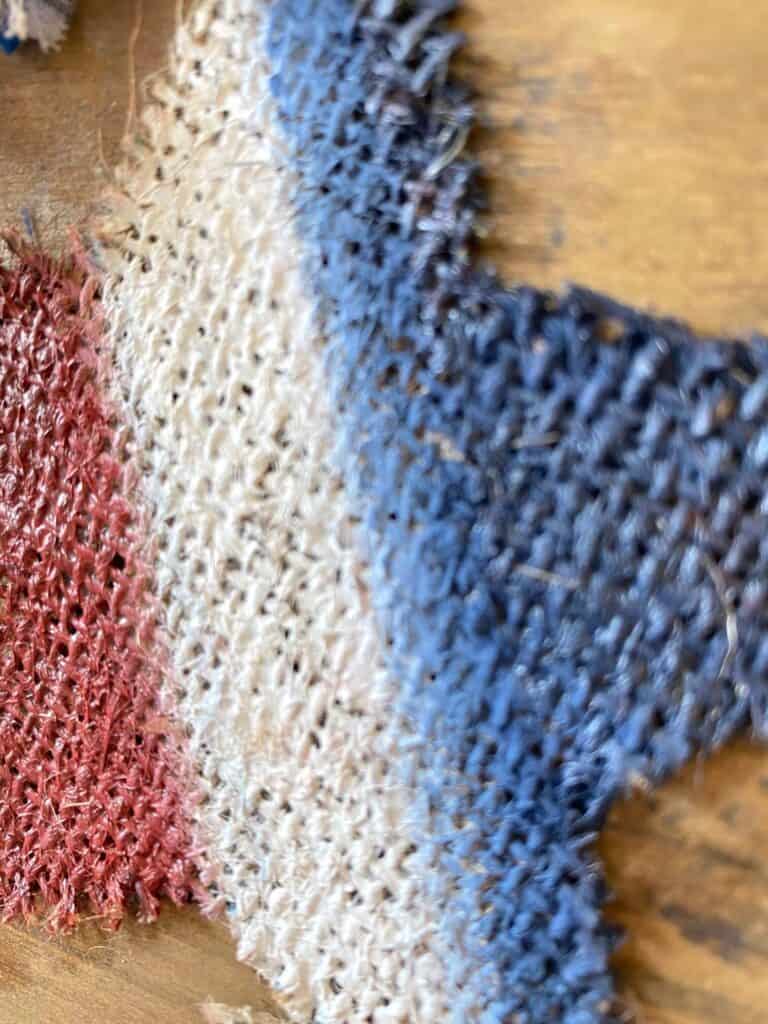 Close up of the red white and blue painted burlap star.