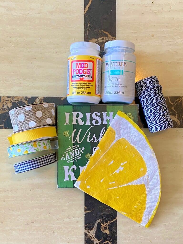 Supplies needed to make a DIY dollar tree lemon napkin shelf or tiered tray sitter with Mod Podge.