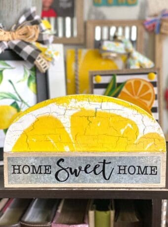 Dollar tree Home sweet home shelf sitter makeover to decorate a lemon themed tiered tray with a lemon napkin mod podged on top.