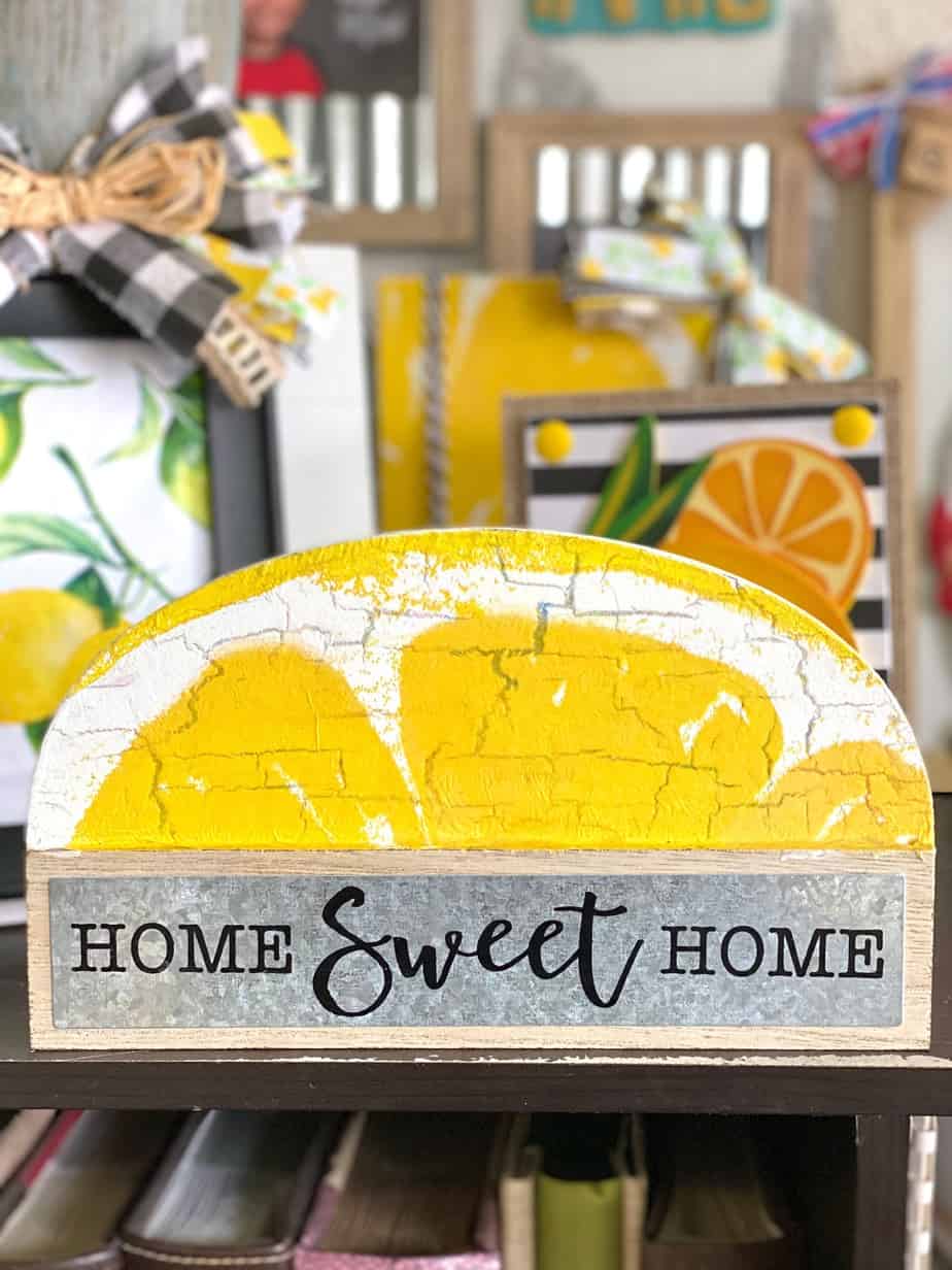 Dollar tree Home sweet home shelf sitter makeover to decorate a lemon themed tiered tray with a lemon napkin mod podged on top.