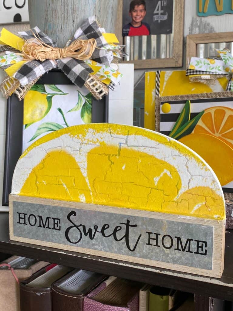 Dollar tree Home sweet home shelf sitter makeover to decorate a lemon themed tiered tray with a lemon napkin mod podged on top and the crackle paint finish showing through for a distressed old look.