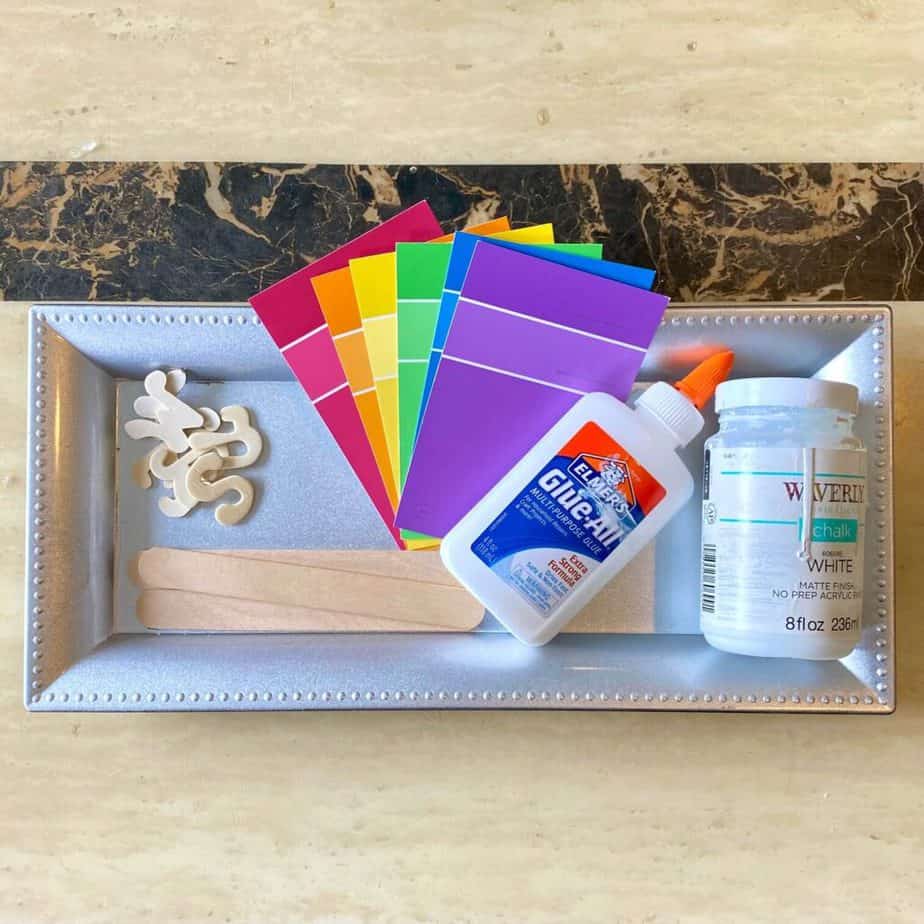 Supplies needed to make a DIY Summer Paint Swatch Popsicle craft with the Paint chip cards that you get from Walmart or Home Depot, on a Dollar Tree Charger plate.