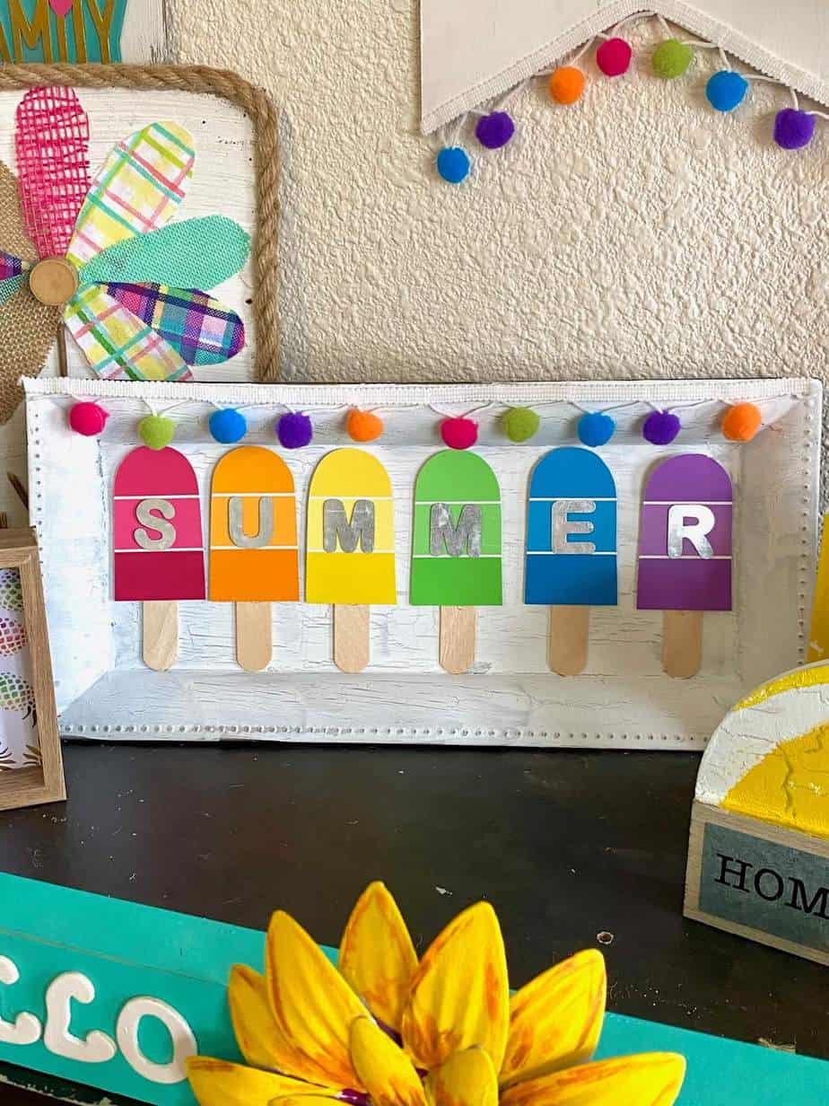 DIY Summer Paint Swatch Popsicle craft made with a dollar tree charger plate and free rainbow colored paint sample cards.