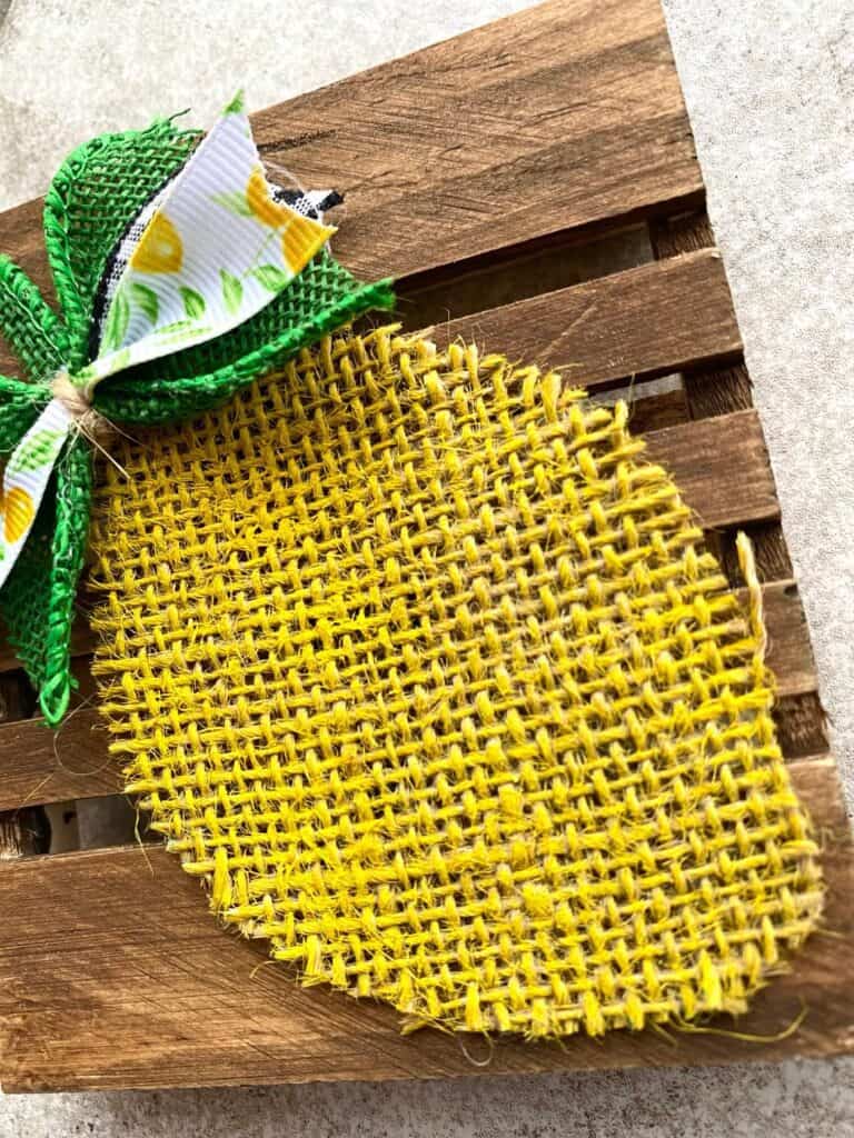 Close up of the lemon shaped piece of Burlap painted yellow.