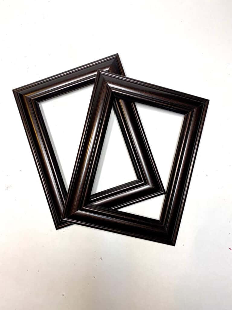 2 wooden black 3x5 picture frames.
