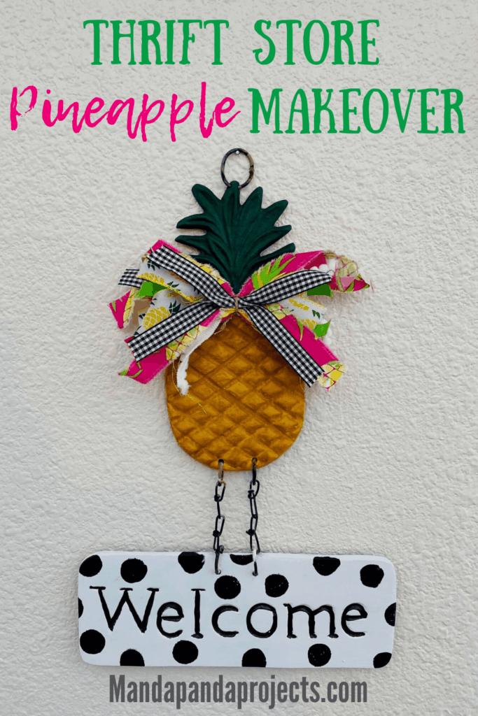 Thrift store Metal pineapple welcome sign that was made over from plaint metal to painted yellow and green with a bow and black and white polka dot Welcome sing.