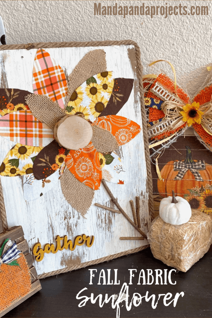 DIY Fall fabric and burlap sunflower with chippy paint background and jute rope rim and a wooden cutout of the word "gather". Autumn decor.