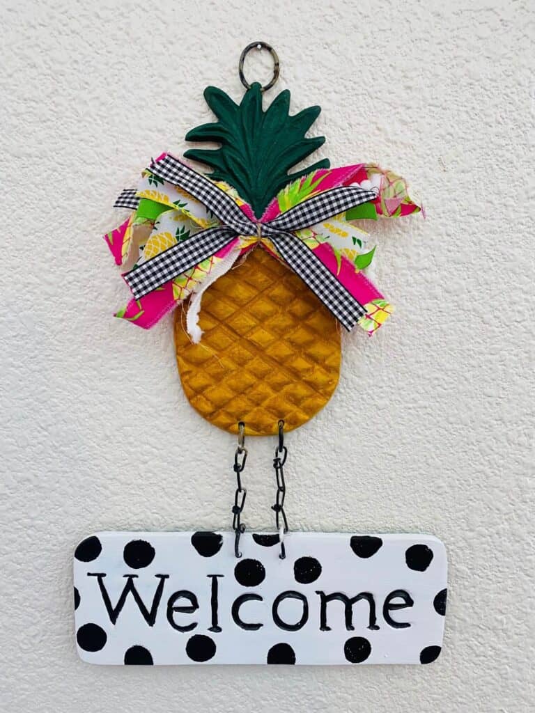 Thrift store find - Metal pineapple welcome sign makeover-thrift store flip from drab to fab. Fun pineapple with bow and black and white polka dot welcome.