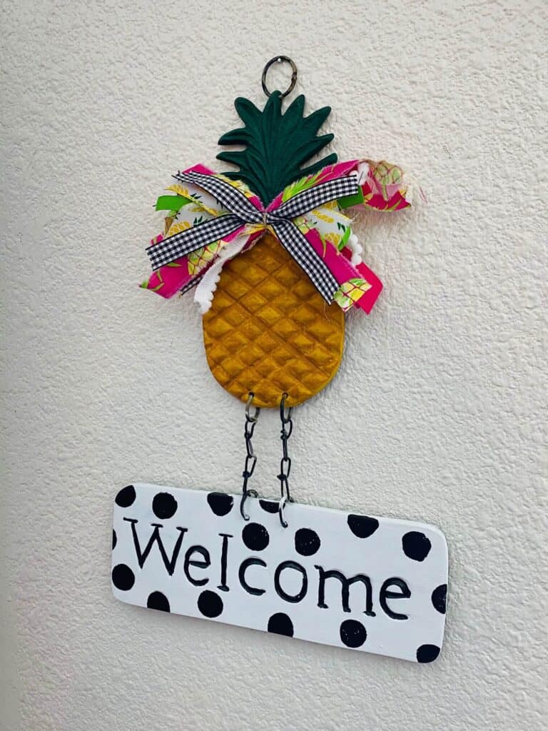 Thrift store find - Metal pineapple welcome sign makeover-thrift store flip from drab to fab. Fun pineapple with bow and black and white polka dot welcome.