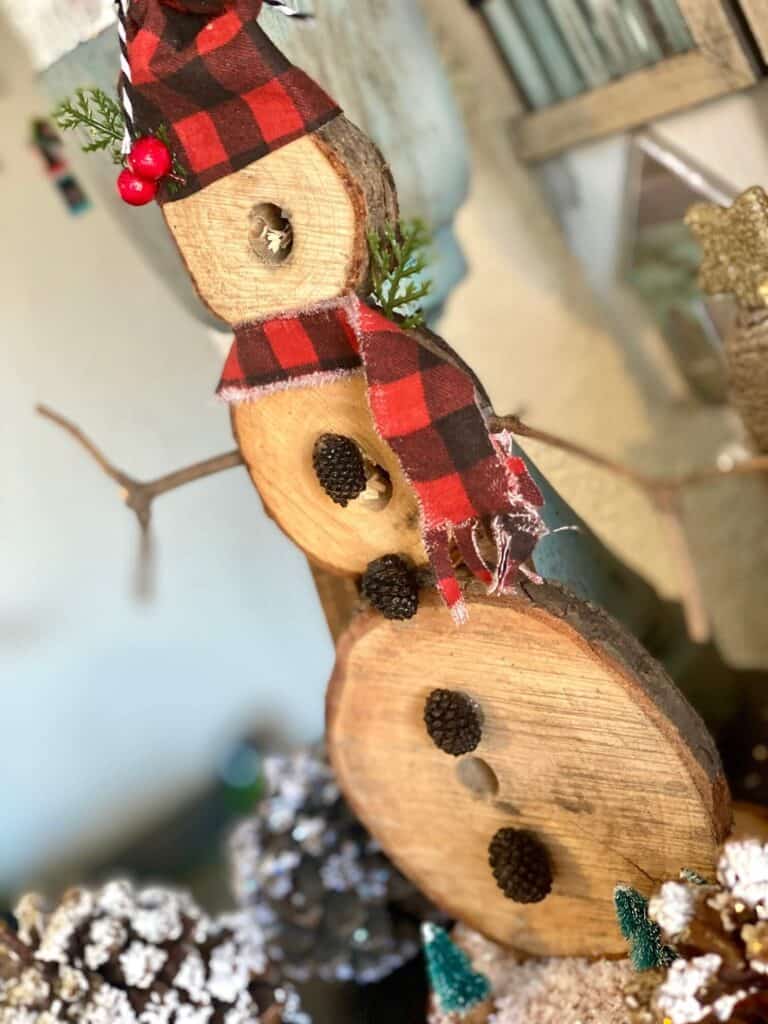 Side view of the DIY Rustic wooden snowman handmade Christmas crafts and decorations for a rustic farmhouse style.