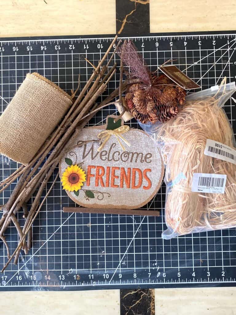Supplies needed to make a dollar tree diy country chic wooden stick pumpkin piece of fall decor.