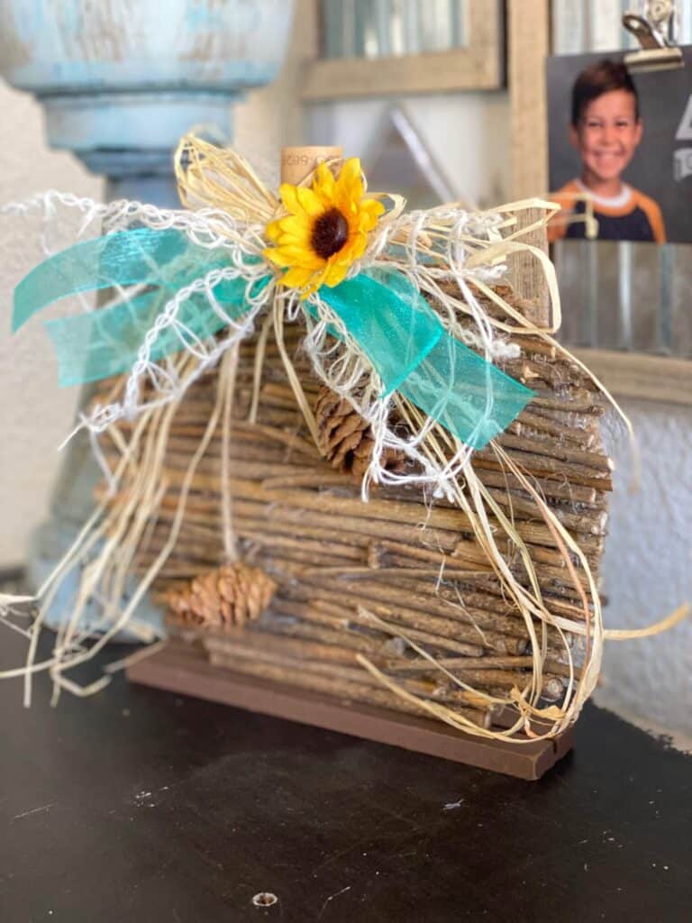 DIY Dollar Tree Rustic Country Wooden Stick Pumpkin Makeover with teal lattice bow and sunflower and pine cone embellishment for fall  diy crafts and decor.