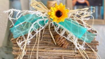 DIY Dollar Tree Rustic Country Wooden Stick Pumpkin Makeover with teal lattice bow and sunflower and pine cone embellishment for diy crafts and decor.