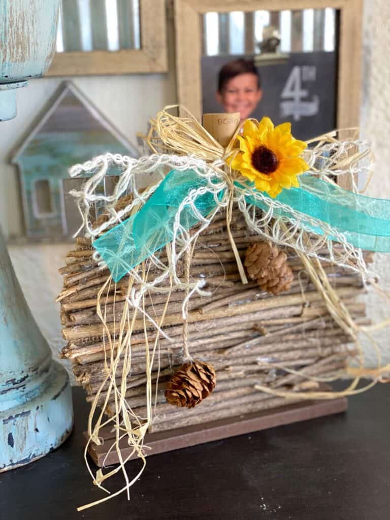 DIY Dollar Tree Rustic Country Wooden Stick Pumpkin Makeover with teal lattice bow and sunflower and pine cone embellishment for fall  diy crafts and decor.