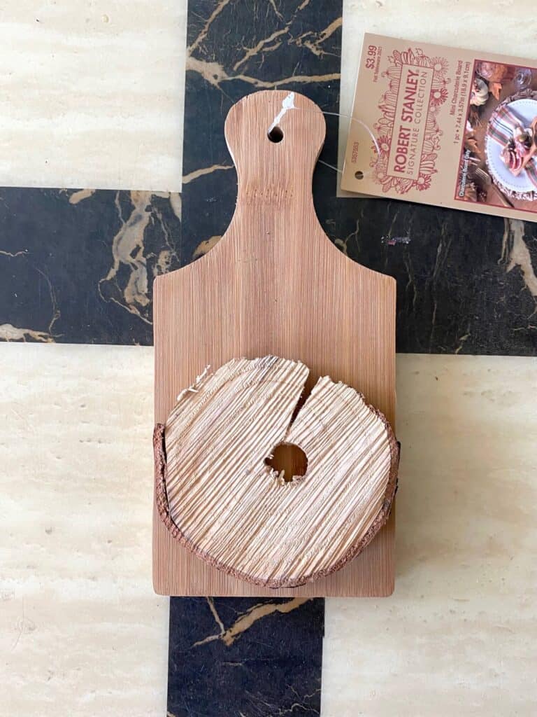 Mini wooden 'robert stanley signature collection" cutting board with a small wooden round glued to the front.