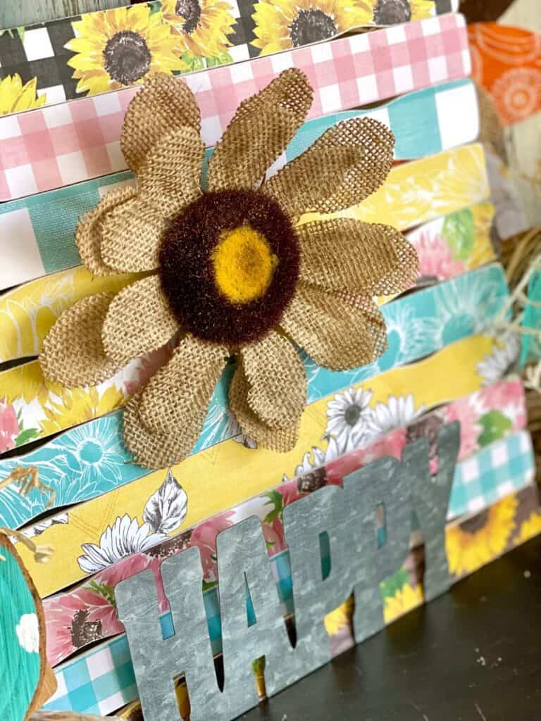 Burlap sunflower and the galvanized metal word "Happy".