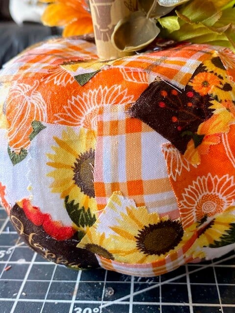 Close up of the patchwork design mod podged to the dollar tree foam pumpkin.