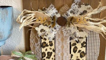 Dollar Tree Leopard Print pumpkin fall DIY crafts and decor with lace, burlap, pearl made on a background of stained paint sticks and jenga blocks with a messy bow.