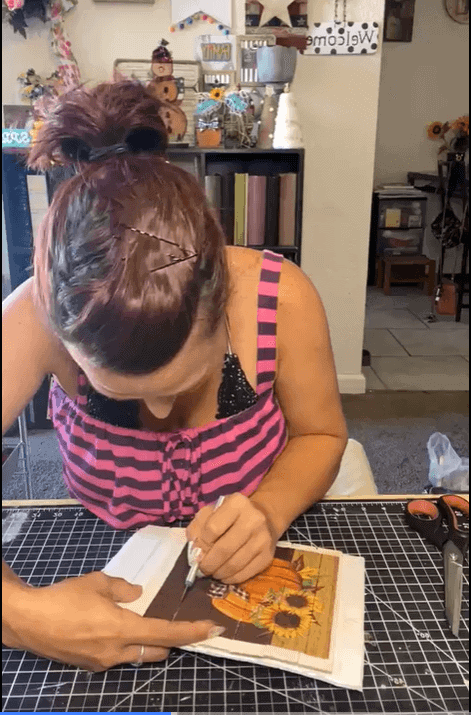 Using an X-acto knife, slit the napkin in between the paint sticks. 