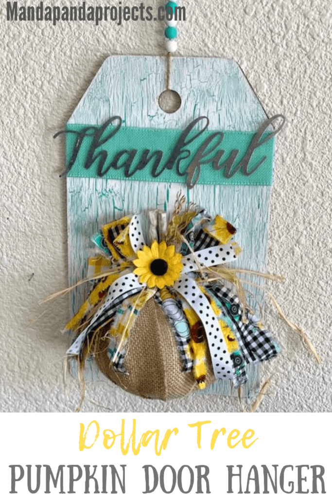 Dollar Tree Burlap Foam Pumpkin Thankful Door Hanger with Teal crackle paint background and sunflowers, truck, buffalo check bow and a wood bead hanger.