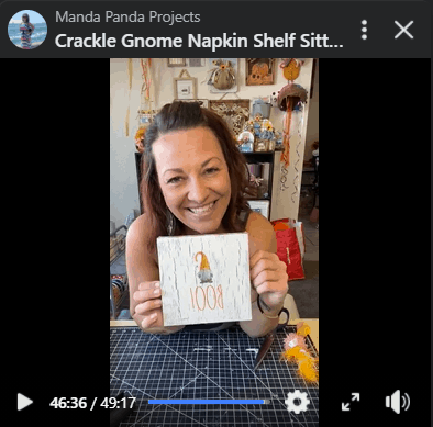 Amanda holding the completed craft project on a Facebook live.