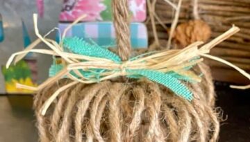 Easy DIY Rustic Twine Pumpkin with a teal and raffia bow and Jute rope stem for fall crafts and decor for a tiered tray.