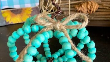 How to make an easy wood bead pumpkin for DIY decor for your fall and autumn tiered tray with teal color theme.