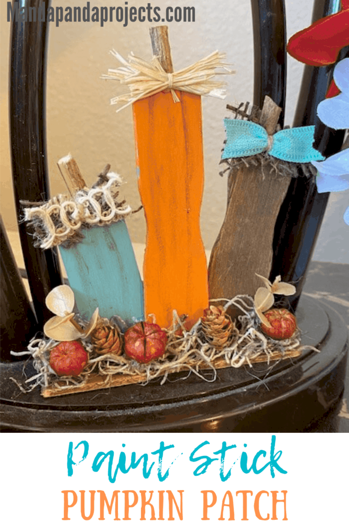 Paint stick pumpkin patch made with recycled ends of paint sticks for a DIY mini piece of fall decor for your tiered tray with Teal, orange and brown pumpkins and mini pinecones with Spanish moss.