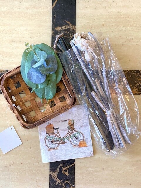 Supplies needed to make a Happy Fall Vintage Bicycle tobacco basket wreath with a burlap and wooden flower.