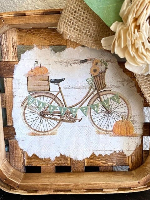 "Happy Fall" vintage bicycle napkin ripped around the edges glued to the center of a mini tobacco basket.
