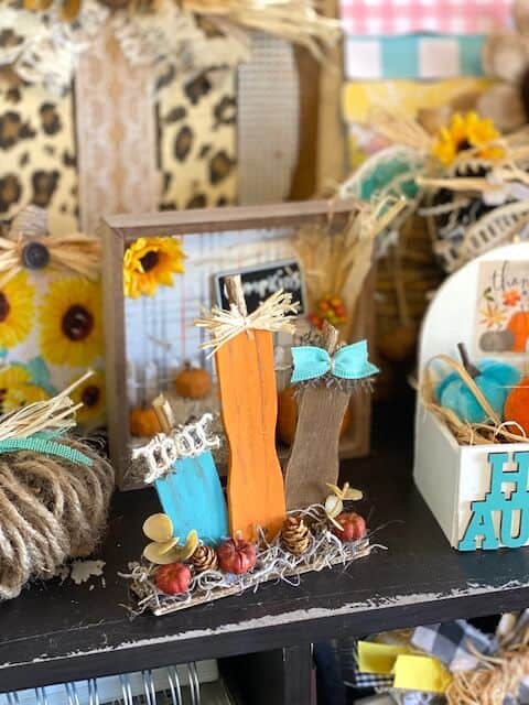 Paint stick pumpkin patch made with recycled ends of paint sticks for a DIY mini piece of fall decor for your tiered tray with Teal, orange and brown pumpkins and mini pinecones with spanish moss.