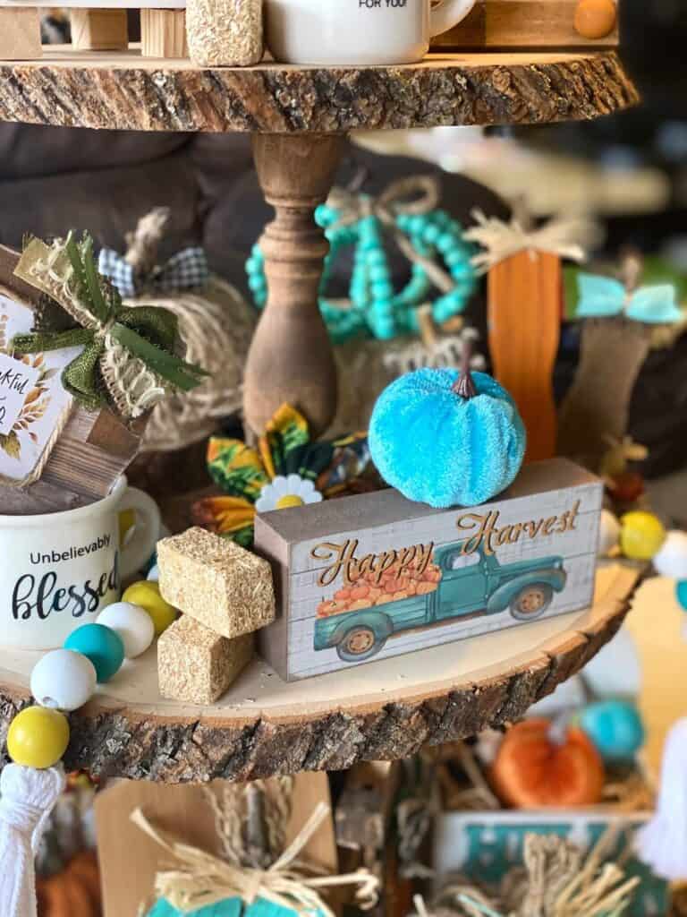 Close up of the Teal pumpkin and mini haybales with the wood bead garland.
