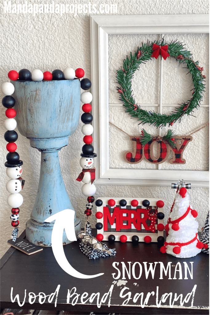 Snowman woodbead garland for a red, white, and black themed DIY christmas tiered tray decor and a handmade tassel with silver bells.