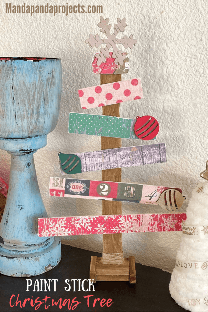 Paint stick Christmas tree with vintage scrapbook paper and wooden ornament embellishments. Handmade vintage Christmas decorations.