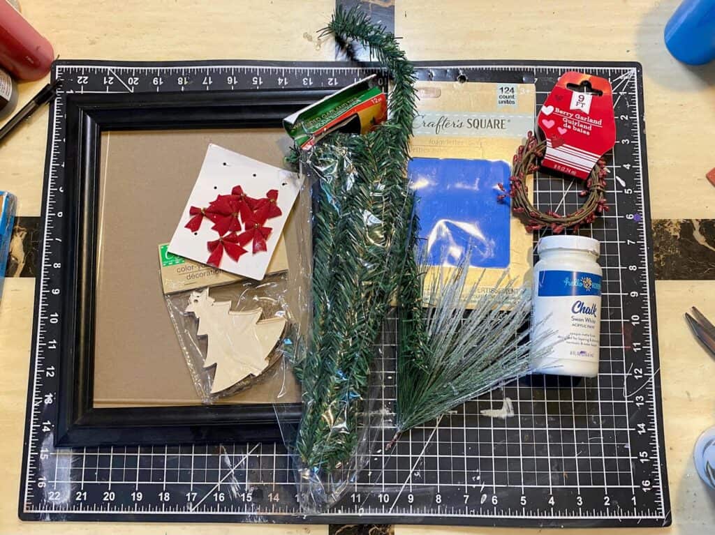 Supplies needed to make a Big Lots copycat Christmas window frame with a thrift store frame and dollar tree supplies.