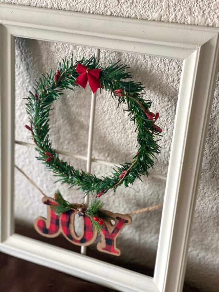 Close up of the Chrsitmas wreath with Joy ornament.