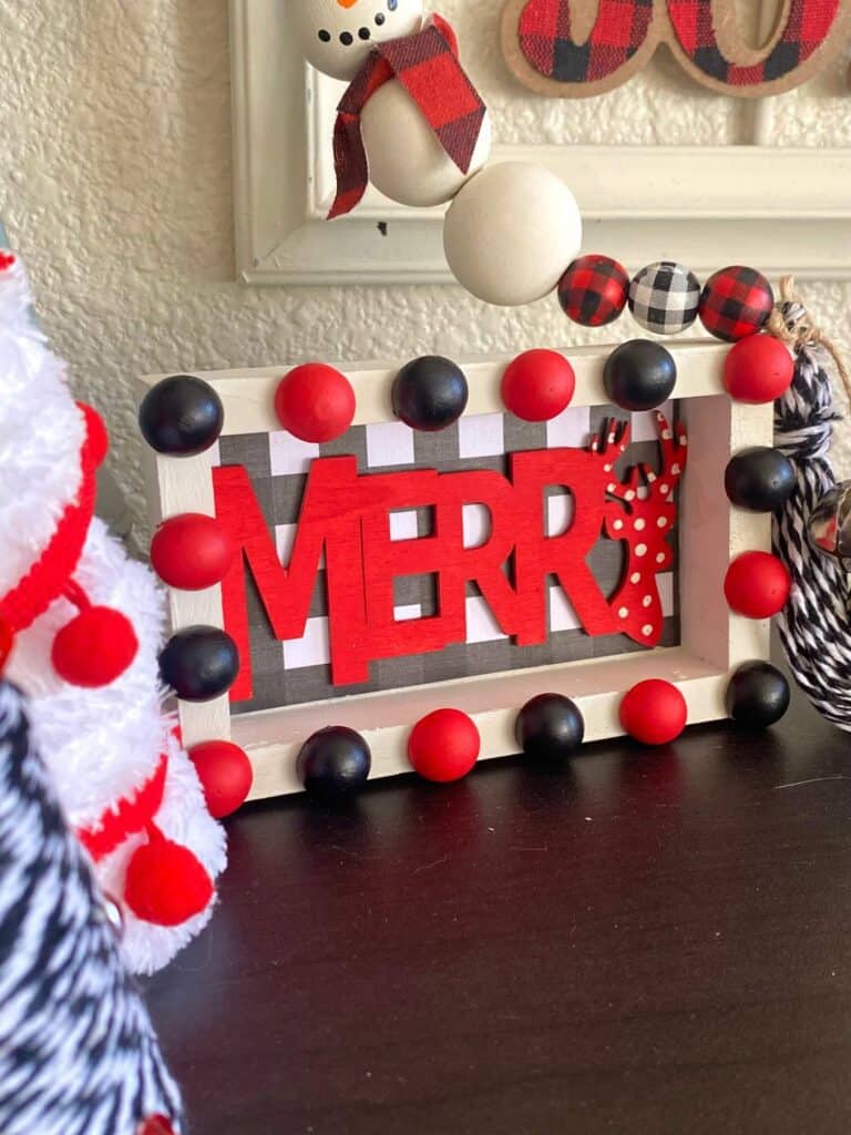 Merry Christmas DIY tiered tray decor sitter. Red, black, and white themed DIY Christmas decor with buffalo check and half wood bead decorative rim.