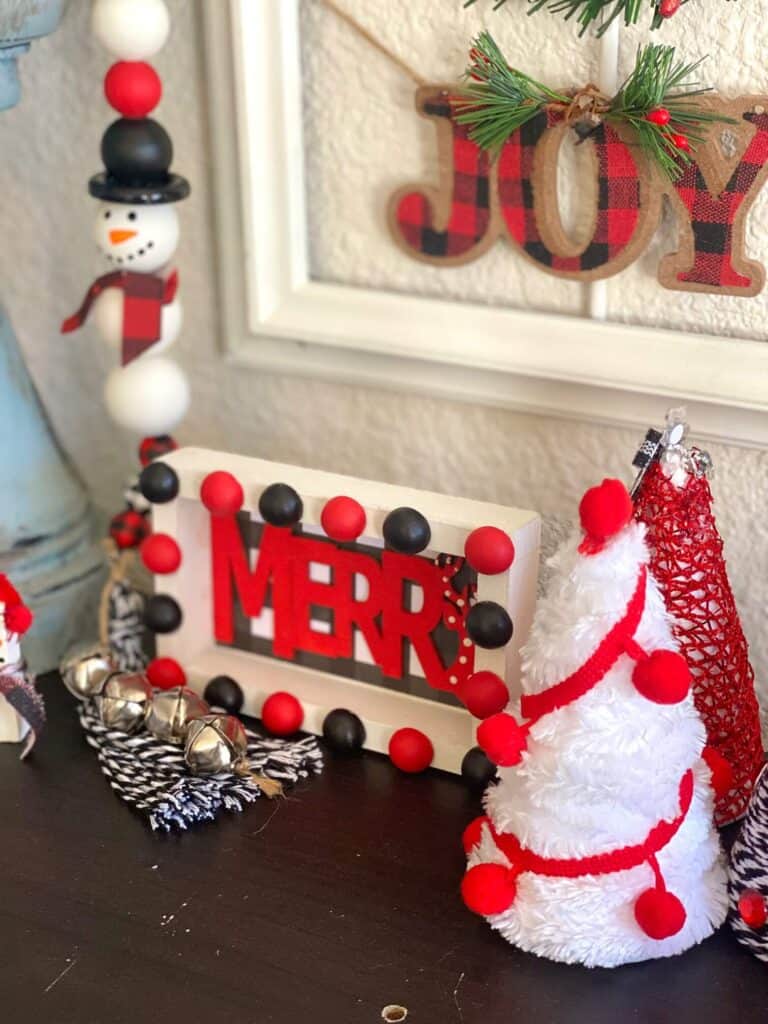 Merry Christmas DIY tiered tray decor sitter. Red, black, and white themed DIY Christmas decor with buffalo check and half wood bead decorative rim.