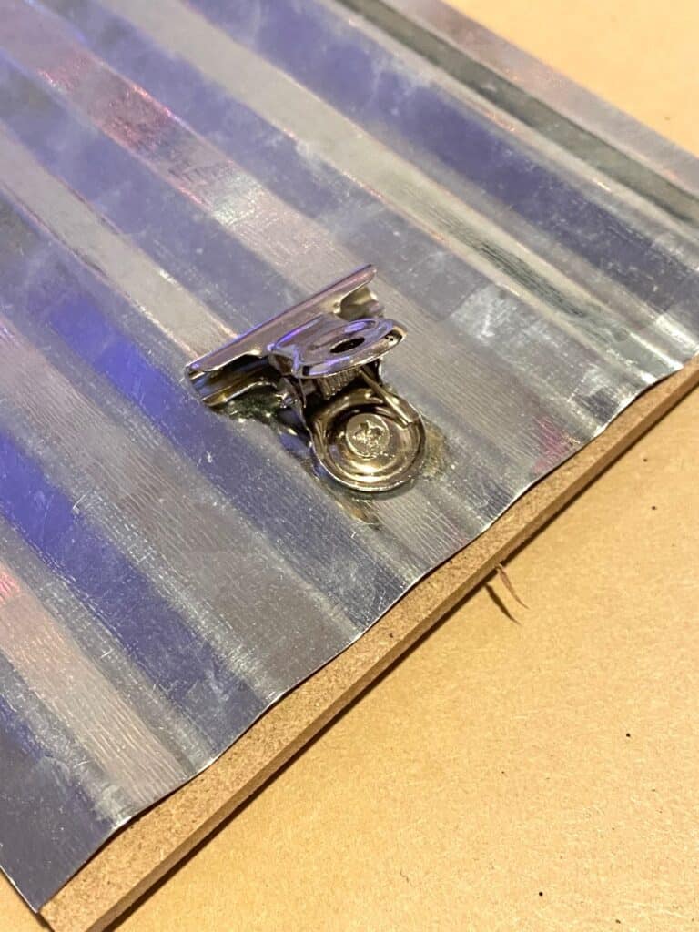 Little metal clip on the dollar tree frame.