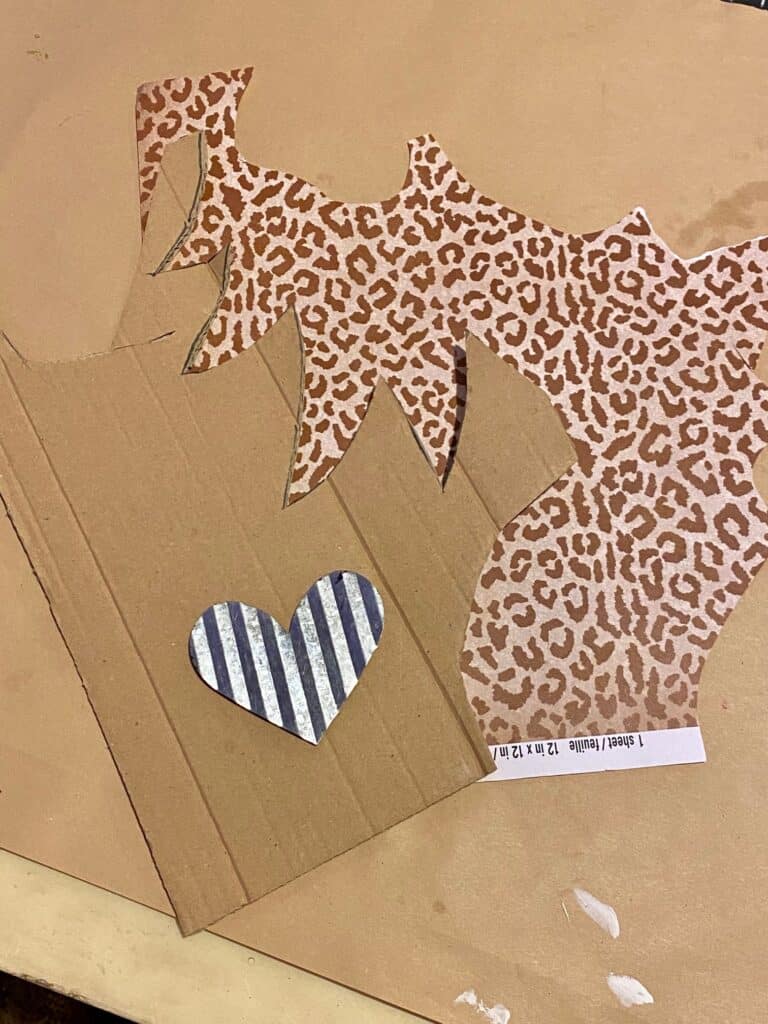 Cardboard, leopard scrapbook paper, and a small galvanized metal heart.