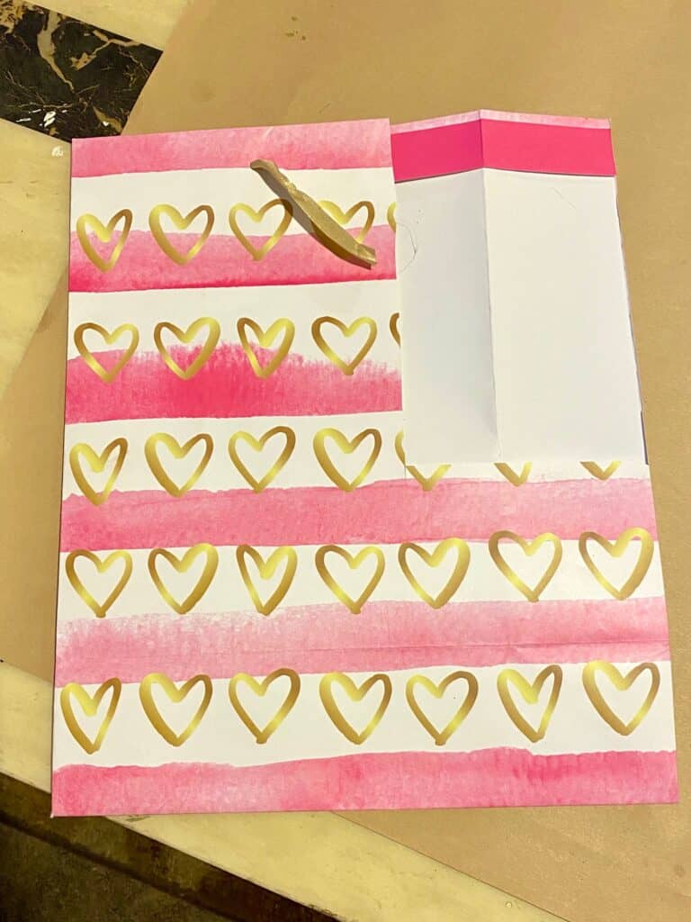 Valentine gift bag from Dollar Tree with pink and gold hearts.