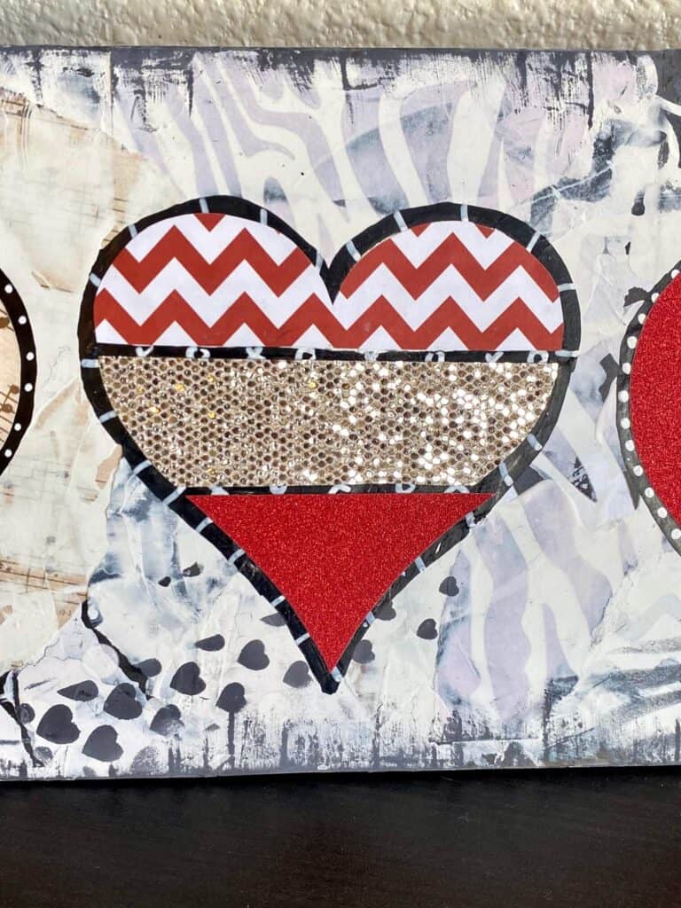 Mixed media heart with red and white zig zag paper, chunky snakeskin glitter paper, and red glitter vinyl.